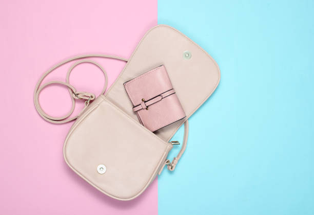 istock Open stylish leather bag with a purse on a pastel background. Top view, minimalism. 1133055774