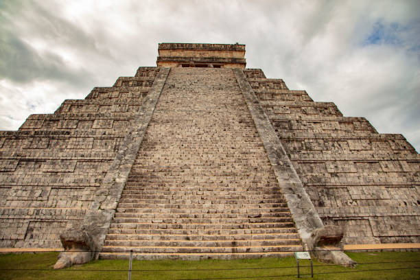 lato nord del tempio di kukulkan o el castillo raffigurante la scala a 91 gradini fiancheggiata dalla testa di serpente piumato di quetzalcoatl è la struttura dominante chichen itza all'interno delle rovine maya nello yucatan centrale, messico - tzompantli foto e immagini stock