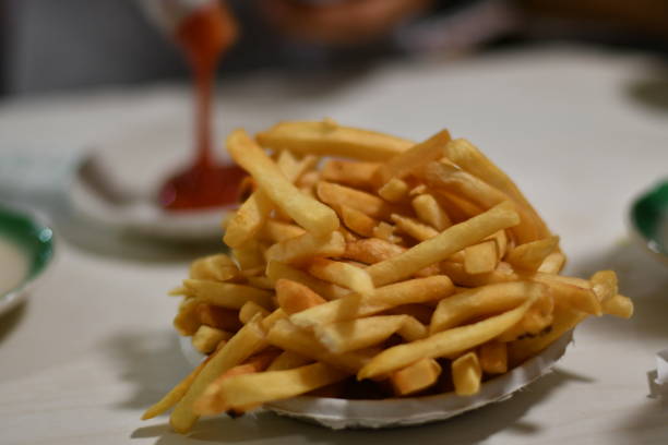 istock French Fries with Ketchup Pour in Background 1133057835