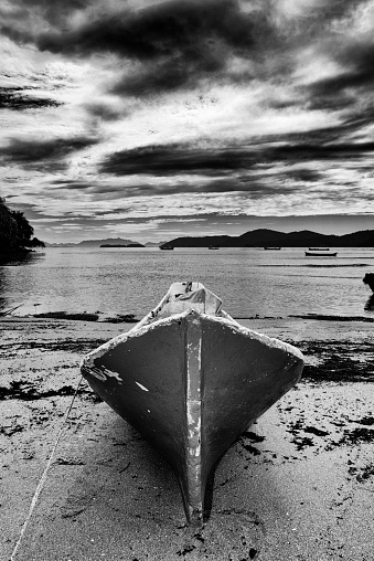 Canoe on the sand of Pontal beach in the bay of Paraty on the southeastern coast of Brazil