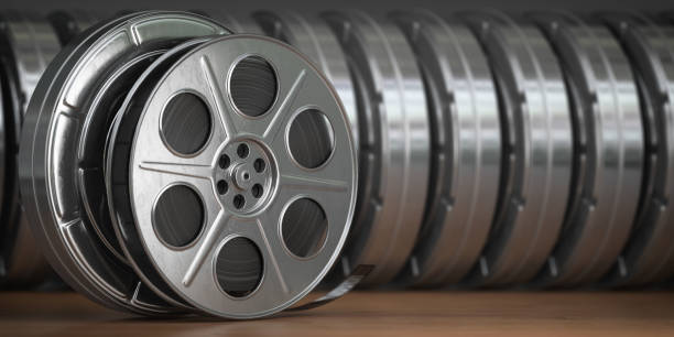 Video, cinema, movie, multimedia concept. A row of vintage film reel or  film spools with filmstrip Video, cinema, movie, multimedia concept. A row of vintage film reel or  film spools with filmstrip  3d illustration spool photos stock pictures, royalty-free photos & images