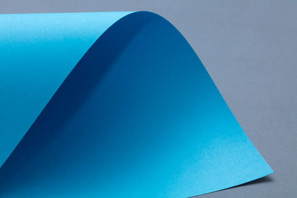 istock Blue Curled paper on gray background. 1133064975