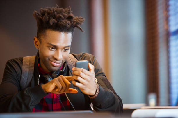 istock Smiling man texting on smart phone at airport 1133067721