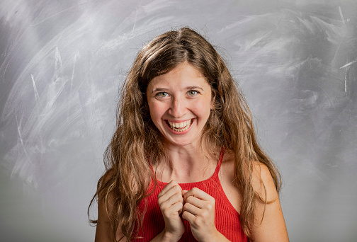 Blonde girl emotion and gesture portrait in studio looking at camera