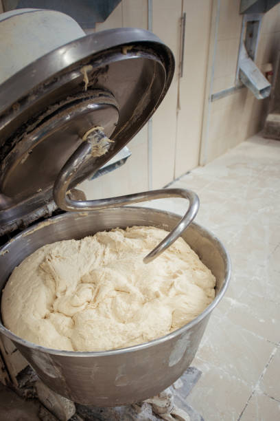 Making dough for bread in a kneader in a bakery Making dough for bread in a kneader in a bakery mixing vat stock pictures, royalty-free photos & images