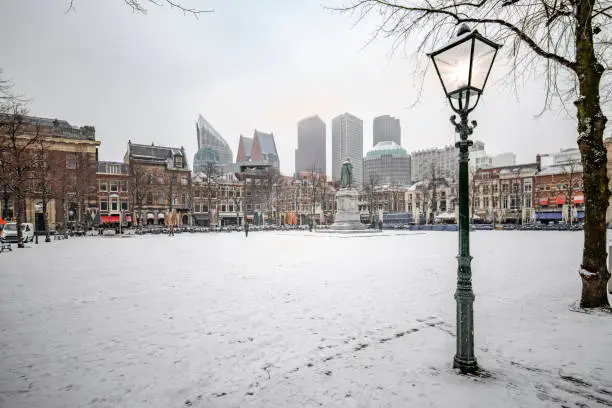 Photo of THE HAGUE, 22 January 2019 -  Snow on the central place, Spui in Dutch, usually crowded with people getting diner and drink during the sunset and warm autumn weather in The Hague, Netherlands
