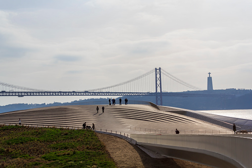 Lisbon cityscape with bridge under river and Christ the King