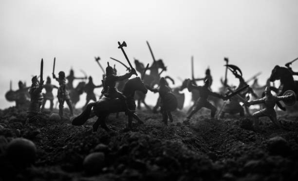istock Medieval battle scene with cavalry and infantry. Silhouettes of figures as separate objects, fight between warriors on sunset foggy background. Selective focus 1133071689