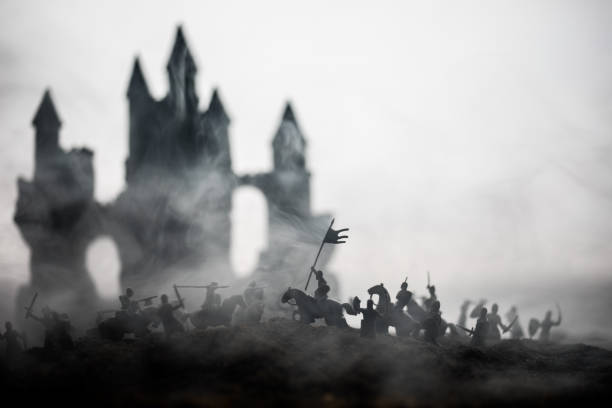 istock Medieval battle scene with cavalry and infantry. Silhouettes of figures as separate objects, fight between warriors on sunset foggy background. 1133071711