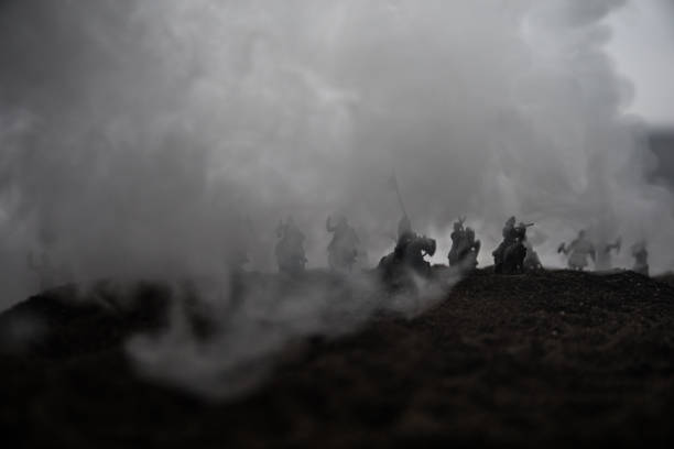 Medieval battle scene with cavalry and infantry. Silhouettes of figures as separate objects, fight between warriors on sunset foggy background.