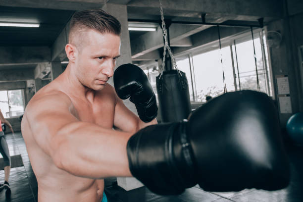 istock young strong sports man boxer make exercises in gym 1133072064