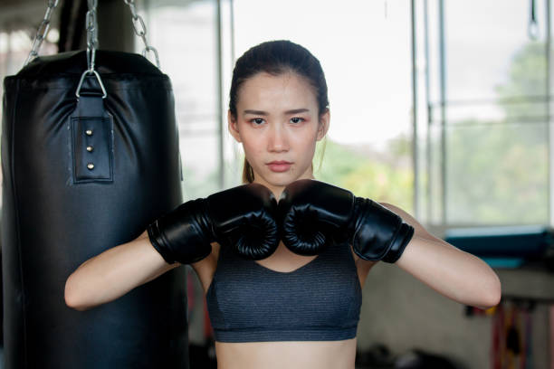 istock Female Punching A Bag With Boxing. 1133073178
