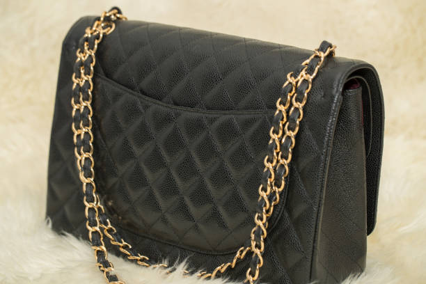 istock Photo of black handbag on the table 1133075996