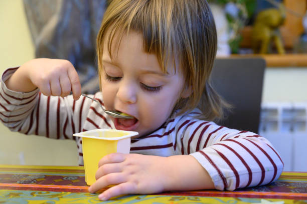 istock Little girl eating at home 1133076991