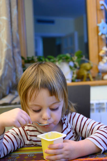 istock Little girl eating at home 1133077897
