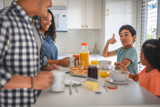 istock Happy family of four having breakfast in kitchen 1133081644