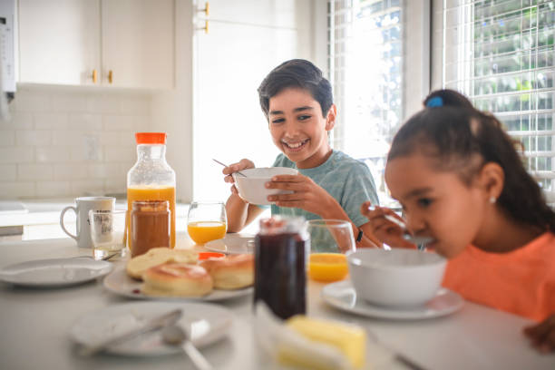 istock Brother and sister having breakfast at home 1133081650