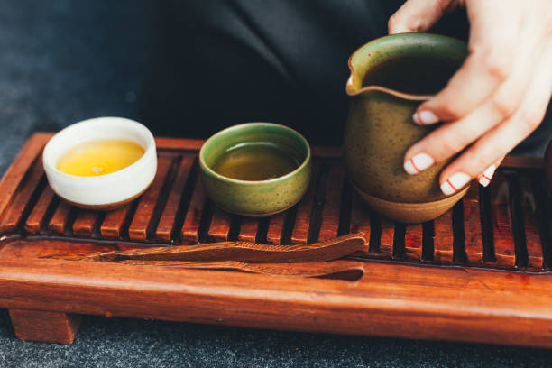 istock Traditional tea ceremony close up with woman hand 1133083954