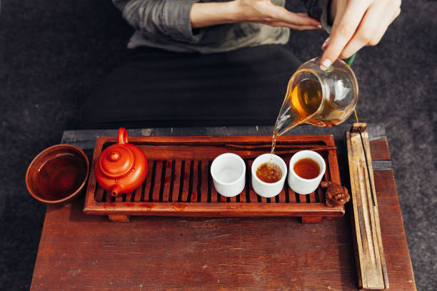 istock Traditional tea ceremony close up with woman hand 1133083957