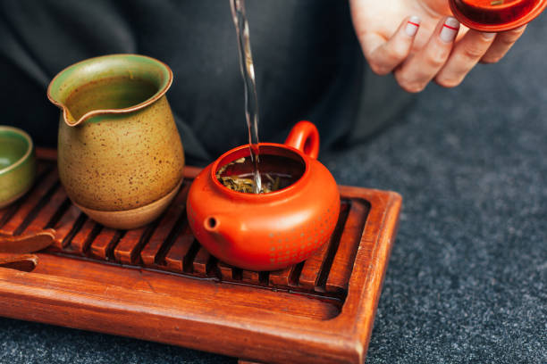 istock Traditional tea ceremony close up with woman hand 1133083959
