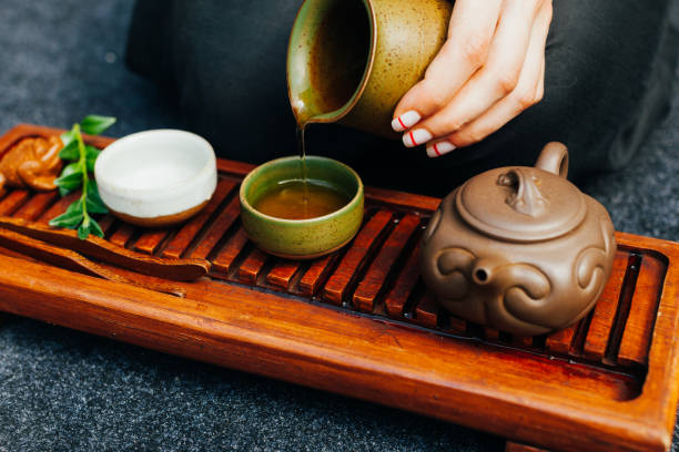 istock Traditional tea ceremony close up with woman hand 1133083965