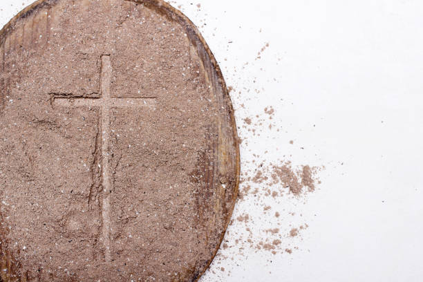 istock Cross and ash on white background - symbol of Ash Wednesday. 1133084157