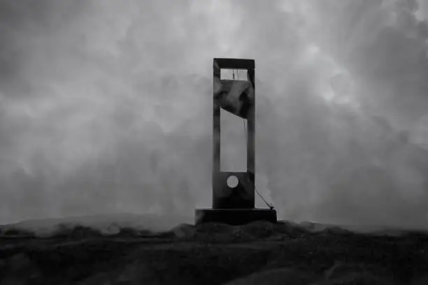 Photo of Horror view of Guillotine. Close-up of a guillotine on a dark foggy background.