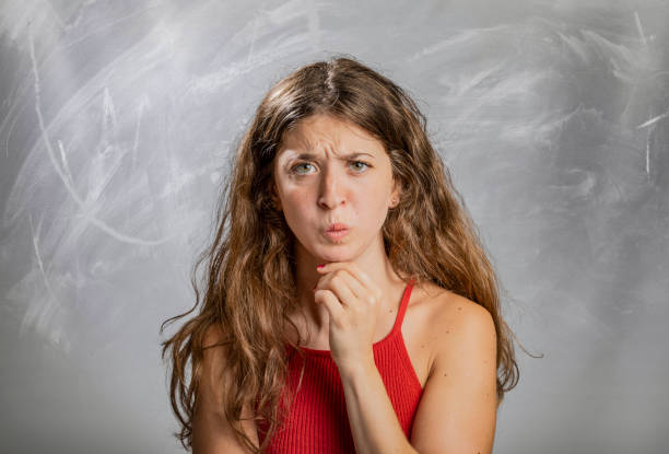 istock Blonde girl emotion and gesture portrait in studio thinking 1133091481