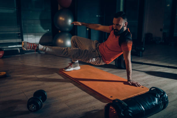istock Handsome man exercising in the gym 1133092538