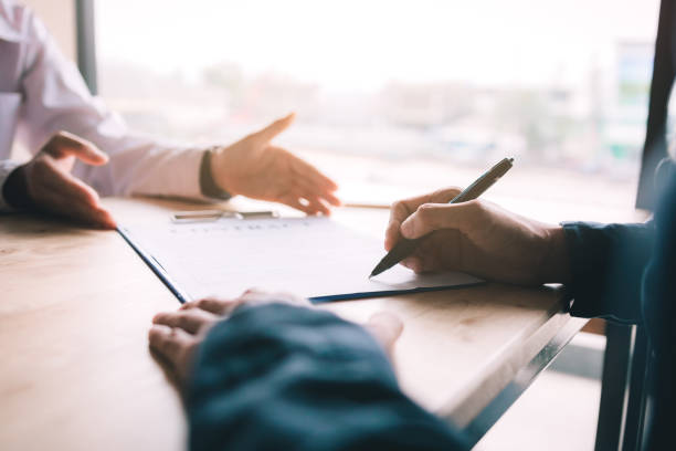 istock Real estate contract on desk with client signing in office. 1133092791