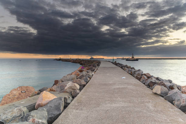 istock Sunrise on the Breakwall Seascape 1133097198