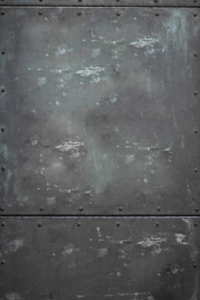 istock close-up Metalic steel rectangular door with nuts texture wallpaper, Dirty rusty metalic background with shadow 1133105349