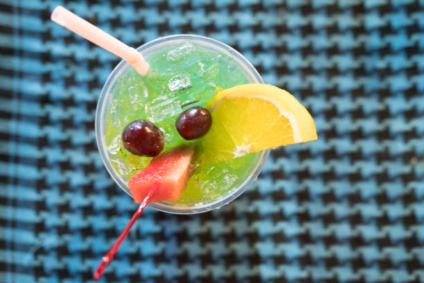 Bright fruit cocktail with piece of fresh fruit, top view