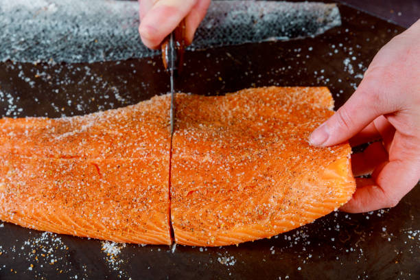 istock Healthy preparation chef is cuting salmon on cutting table board. 1133107825