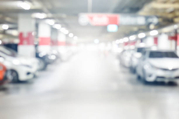 istock blur underground cars parking garage with light on exit way use as background 1133108797