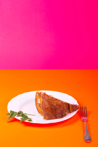 istock A large piece of fresh pork ham on a plate on a colored background 1133109387