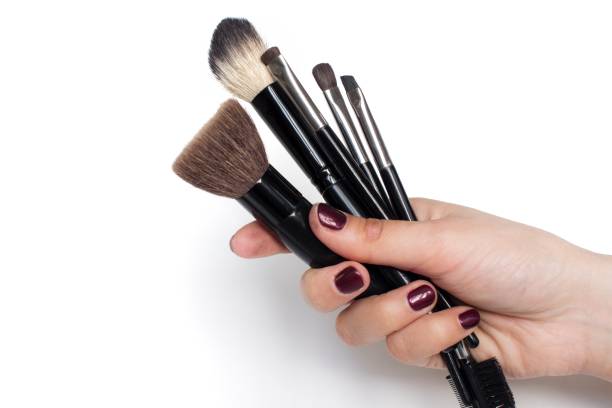 istock young woman holding make-up brushes in her hand 1133110134