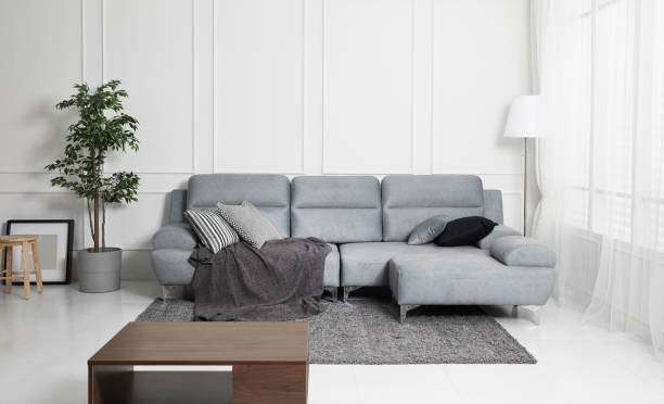 istock Scandinavian style livingroom with fabric sofa, sofa table. morning image with plant. sofa table on the lug. 1133112703