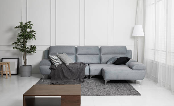 istock Scandinavian style livingroom with fabric sofa, sofa table. morning image with plant. sofa table on the lug. 1133112707