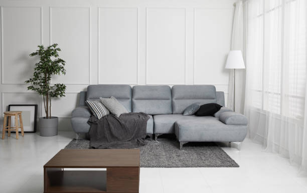istock Scandinavian style livingroom with fabric sofa, sofa table. morning image with plant. sofa table on the lug. 1133112721