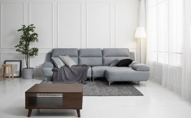 istock Scandinavian style livingroom with fabric sofa, sofa table. morning image with plant. sofa table on the lug. 1133112722