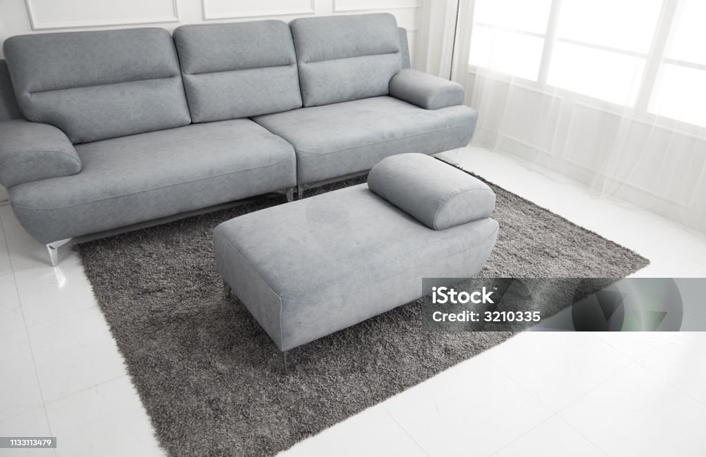 Scandinavian style livingroom with fabric sofa, sofa table. morning image with plant. sofa table on the lug. Advertisement Stock Photo