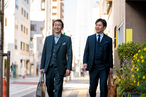 Two mature businessmen outdoors. Tokyo, Japan
