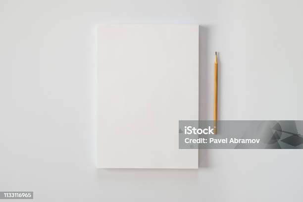 A Stack Of Blank Sheets Of Paper And A Pencil On A White Background Creative Crisis Or The Beginning Of A New Novel Stock Photo - Download Image Now