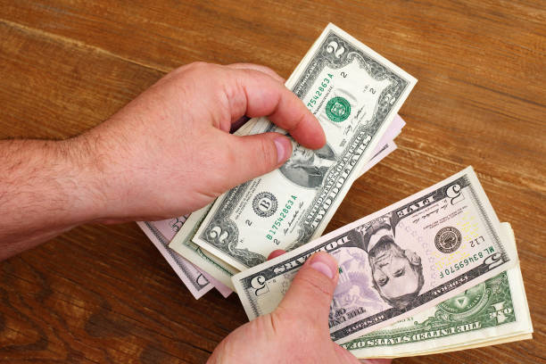 istock top view of hands counting small dollar bills 1133117115