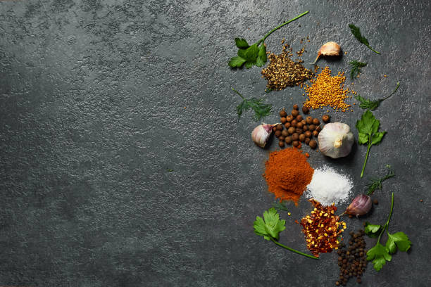 istock Various herbs and spices on black background. Salt, Garlic,turmeric, pepper peas. Top view with copy space. 1133117991