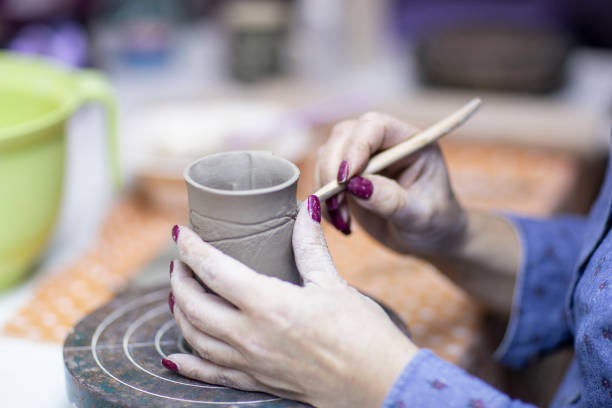 istock Hands of artist who make a mug from ceramic clay in studio 1133123432