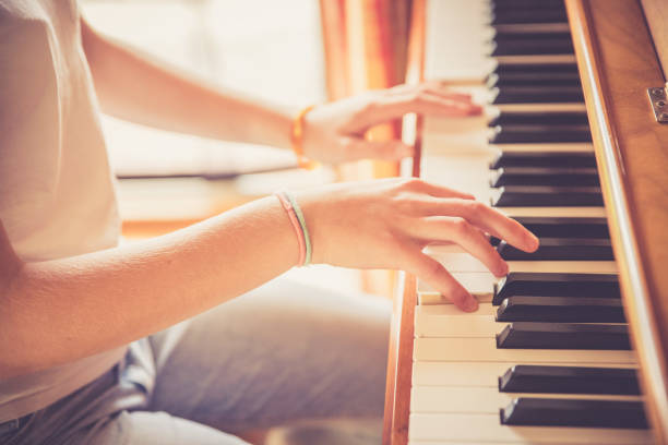 istock Girl is playing piano at home, high angle view, blurry background. 1133123501