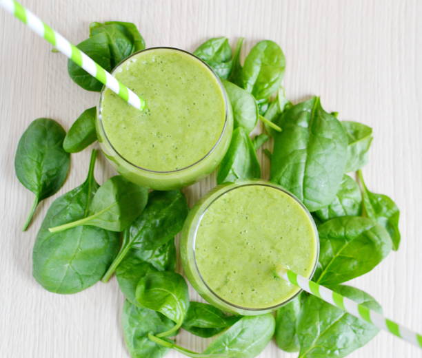 istock Green spinach smoothies with fruits 1133123616