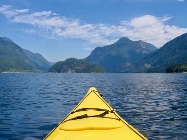 istock A yellow kayak head points to the beautiful mountains and ocean. 1133124801
